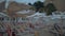 Empty sunbeds under umbrellas on resort in windy evening