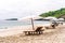 Empty sunbeds waiting for tourists on Virgin beach or Pasir Putih or Perasi Beach on Bali, Indonesia. Beautiful and clean tropical