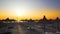 Empty sunshades, chairs and sunbedsstand on beach at sunset