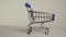 empty supermarket cart close-up on a white background. slow motion