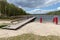 Empty swimming pool in Central Europe. Wooden jetty on the lake