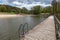 Empty swimming pool in Central Europe. Wooden jetty on the lake