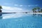 An empty swimming pool with palm trees in the background