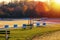 Empty swimming pool with red lifeguard stand in the autumn sundown. Very large swimming pool in the fall sunset.