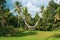 Empty swing over beautiful rice fields with tropical palm trees background