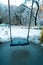 Empty swing in the playground in the park, wooden swing, wooden swing in winter, icicles on the swing
