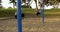 Empty swing set in the park. Children`s playground without players.