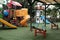 Empty swings in kindergarten. Playground closed for children in pandemic. Unattended slide and swing set during coronavirus