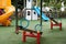 Empty swings on kindergarten playground. Unattended slide and swing set during coronavirus outbreak. Closed for children in