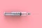Empty syringe closeup isolated on pink background, High resolution, Top view with copy space, Medical concept.