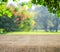 Empty table covered with sackcloth over blurred trees with bokeh background