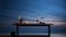 An empty table in front of a plane wall, captured at twilight for a serene product display