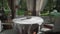 Empty table in restaurant with white tablecloth. Panoramic windows, no clients.