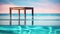An empty table stands gracefully, a blurred Swimming pool background