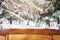 Empty table top with blurred spruce trees with snow on the background.