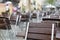 Empty tables and chairs in front of a restaurant in the rain