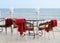 Empty tables at hotel restaraunt with red plaids on the beach