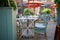 empty tables and large umbrella Parasol at cafe with plants and glass cups