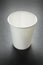 Empty takeaway cup of coffee, tea or juice on black, mockup. Vertical