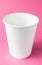 Empty takeaway cup of coffee, tea or juice on isolated pink background, mockup. Vertical