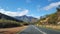 Empty tar road in the Western Cape, South Africa with scenic mountain ranges and natural vegetation