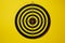 The empty target for a darts - dartboard isolated on yellow background