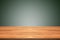 Empty teak wood table top on green gradient background,space mon