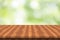 Empty teak wood table top on nature green blurred background,space for montage show products