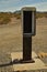 Empty telephone booth in desert outdated technology