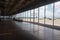 empty terminal with view of the tarmac, showcasing bustling airport in the background