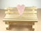 Empty timber chair with pink heart shape