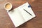 Empty TO DO LIST and coffee in cup on wooden table