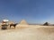 Empty touring horse cart close Egyptian pyramids under the clear blue sky