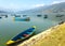 Empty tourist boats on the lake Pheva, mountain view