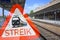 An empty train station with the information sign and the German word `STREIK`