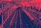 Empty train tracks across the Williamsburg Bridge from Brooklyn to Manhattan in New York City with red blue duotone colors