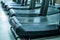 Empty treadmills set in gym interior close