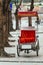 Empty tricycle with red seat stop on the foot path under the tree in Hanoi, Vietnam