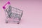 Empty trolley on soft pink background, buy and sell concept