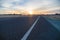 Empty turning asphalt road closeup and sunrise cloudscape