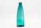 Empty turquoise glass bottle isolated on a white background with a clipping path.