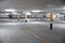 Empty underground car parking lot in Europe. Wide-angle view, neon lights, no people
