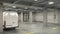 Empty underground parking with white van