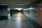 An empty underpass in marble. Columns and light create rhythm