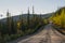 Empty unpaved Highway through the Alaskan wilderness