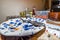 Empty used colorful plate with fork spoon and knife after food eaten on wooden dinner table