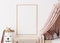 Empty vertical picture frame on white wall in modern child room. Mock up interior in scandinavian style. Free, copy