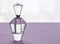 Empty vintage crystal glass perfume bottle with stopper on lilac