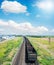 Empty wagons on railroad under blue sky