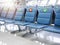 Empty waiting chairs with social distancing sign, green check mark and red cross mark